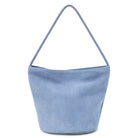 Vancouver suede bucket bag in dusty blue with a single shoulder strap, shown on a white background